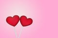 Two Red Lollipops Shape of the Heart on Pink Background. Valentine`s Day Concept
