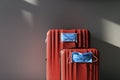 Two red luggages with protective masks