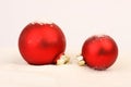 Two red matt christmas balls on snow