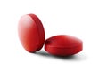 Two red medical pills with shadows on isolated white background. Pills with round shape. Royalty Free Stock Photo