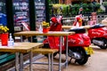 Two Red Motor Scooters Parked Outside An Empty Resaurant