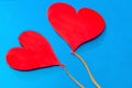 Two red paper hearts on blue background Royalty Free Stock Photo