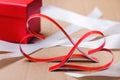 Two red paper hearts, a white packing tape and a box with a gift for Valentines Day. Love symbol concept Royalty Free Stock Photo