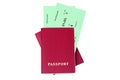 Two red passports, green flight boarding pass ticket white background isolated closeup top view, airplane travel, check in control