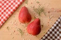 Two red pears on a wooden table like christmas nuance