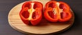 Two red peppers halved on wooden board, natural produce for food preparation Royalty Free Stock Photo