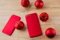 Two red phones and Christmas balls. Royalty Free Stock Photo