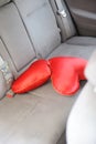 Two red pillows in the shape of heart on the back seat of car Royalty Free Stock Photo