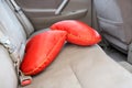 Two red pillows in the shape of heart on the back seat of car Royalty Free Stock Photo