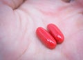 Two red pills in hand Royalty Free Stock Photo