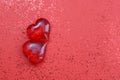 Two red plastic hearts are on a red background Royalty Free Stock Photo