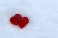 two red plastic hearts are on white snow Royalty Free Stock Photo