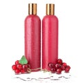 Two red plastic shampoo and hair conditioner bottles, shower gel and lotion in water drops on white background isolated close up Royalty Free Stock Photo