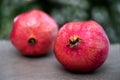Two Red Pomegranates On Blurred Background