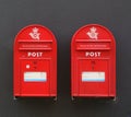 Two red postbox. Denmark a black wall. Denmark