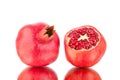 Two red ripe pomegranates whole and cutted on white background isolated close up Royalty Free Stock Photo