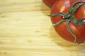 Two red ripe tomatoes on wooden cutting board Royalty Free Stock Photo