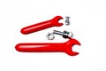 Two Red rubber insulated electrical wrenches with nut and bolt Royalty Free Stock Photo