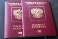 Two red Russian passports on a wooden background. Isolated