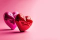 Two red shiny glossy hearts with decorative ornaments on a pink background. Generative AI, generative artificial intelligence