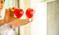 Two Red Smiling Hearts held by female nurse`s hands, representing giving effort high quality service mind to patient. Profession