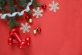 Two red sports dumbbells and Christmas tree with snowflakes and red balls, white measuring tape on red background with copy space Royalty Free Stock Photo