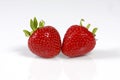 Two red strawberrys on white background.