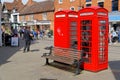 Two red telephone boxes and a street musician Royalty Free Stock Photo