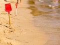 Two red toy shovels in sand on beach Royalty Free Stock Photo