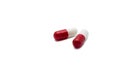 Two red and white pills capsules on white background Royalty Free Stock Photo