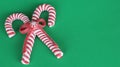 Candy canes on a green background
