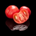 Two red whole and one half-cut tomato Royalty Free Stock Photo