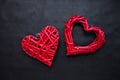 Two red wicker hearts on a black background. Valentine's day concept for your design Royalty Free Stock Photo