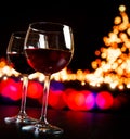 Two red wine glass against bokeh lights tree background Royalty Free Stock Photo