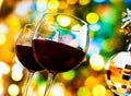 Two red wine glasses against colorful bokeh lights and sparkling disco ball background Royalty Free Stock Photo