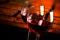 Two red wine glasses on wood table with warm atmosphere background Royalty Free Stock Photo