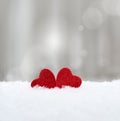 Two Hearts in the snow on grey background. Valentines day concept.