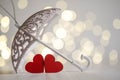 Two red wooden hearts under an umbrella Royalty Free Stock Photo