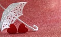 Two red wooden hearts under an umbrella Royalty Free Stock Photo