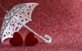 Two red wooden hearts under an umbrella Royalty Free Stock Photo