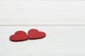 Two red wooden hearts on white wooden background. Valentine`s day or Love concept. Royalty Free Stock Photo