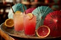 Two Refreshing Cocktails with Citrus and Paper Umbrellas Royalty Free Stock Photo