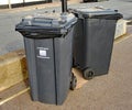 Two refuse bins padlocked to a lamppost on the Esplanade in Sidmouth, Devon