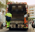 Two refuse collection workers loading garbage into waste truck emptying containers Royalty Free Stock Photo