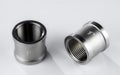 Two regular couplings of white metal with an internal thread Royalty Free Stock Photo