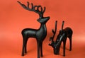 Two Reindeer Figurines on Red Background