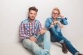 Two relaxed fashion men sitting on the floor Royalty Free Stock Photo