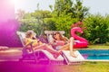 Portrait of couple girls relax on pool deck chair