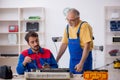 Two male repairmen repairing air-conditioner Royalty Free Stock Photo