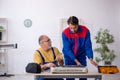 Two male repairmen repairing air-conditioner